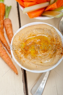 fresh hummus dip with raw carrot and celery 