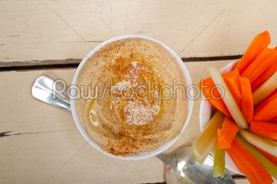 fresh hummus dip with raw carrot and celery 