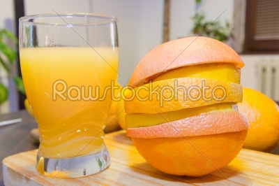 fresh orange juice and slices on wooden board