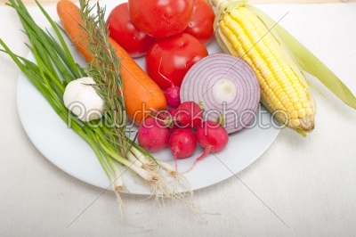 fresh vegetables and herbs on a plate 