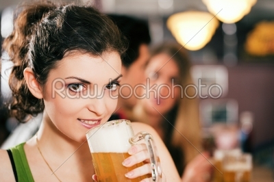 Friends drinking beer in bar