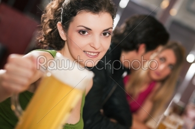 Friends drinking beer in bar