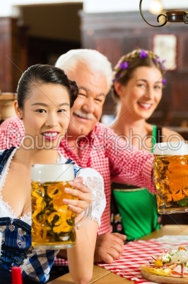 friends drinking beer in Bavarian pub
