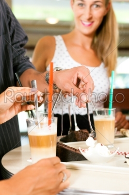 Friends drinking milk coffee and eating cake
