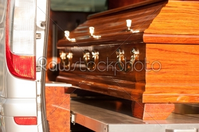 Funeral with coffin in hearse