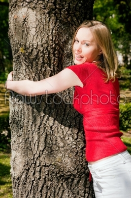 Girl cuddling a tree