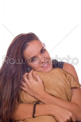 girl holding a pillow and smiling