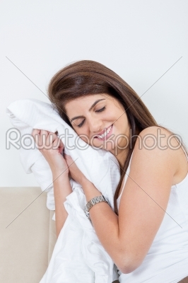 girl hugging sheets like pillow