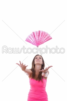 girl in pink dress throwing fan