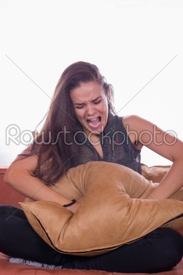 girl screaming and punching the pillow