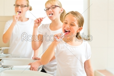 Girls tooth brushing in the bath room