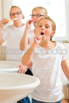 Girls tooth brushing in the bath room