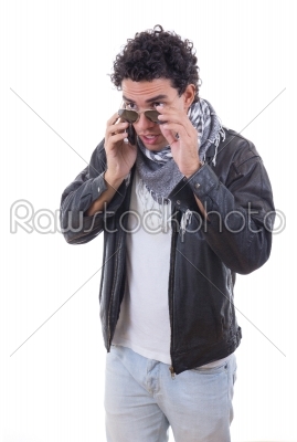 good looking man in a leather jacket talking over phone