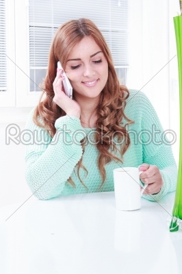 gorgeous girl drinking coffee and talking on the phone
