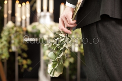Grief - man with white roses at urn funeral