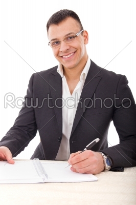 handsome businessman writing in notebook