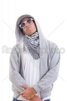 handsome fashion man in track suit standing cool with hood and s