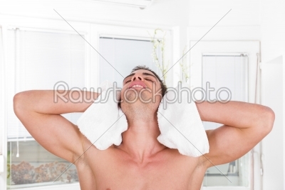 handsome guy drying hair with white towel