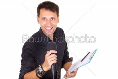 handsome male journalist reporting news on microphone with notes