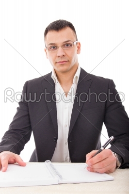handsome male teacher writing in notebook