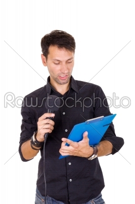 handsome man giving speech on microphone reading notes