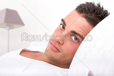 handsome man lying in bed