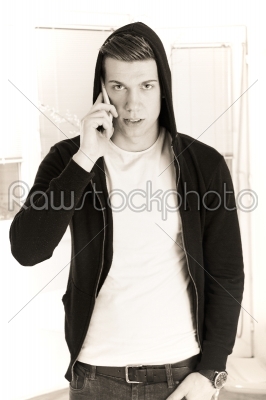handsome man with hooded on the phone