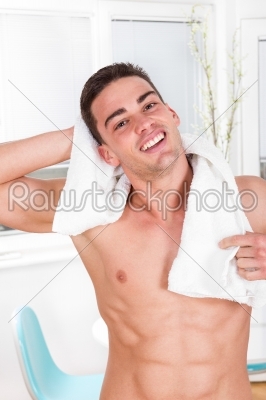 handsome smiling man holding towel around his neck
