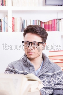 handsome young man studying and reading books