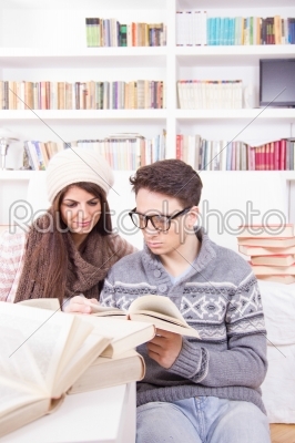 happy couple reading books at home