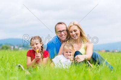 Happy Family outdoors sitting on grass