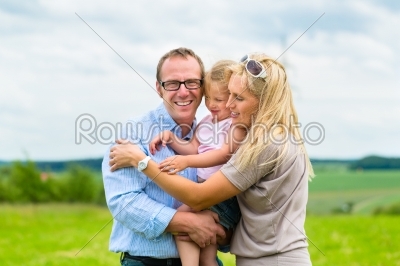Happy Family with child in the meadow