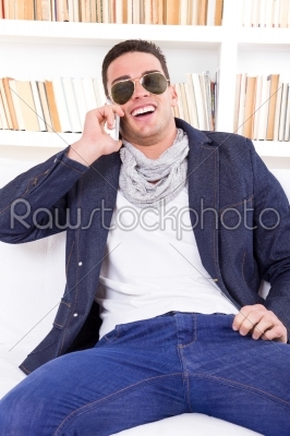 happy modern man wearing sunglasses talking on the phone