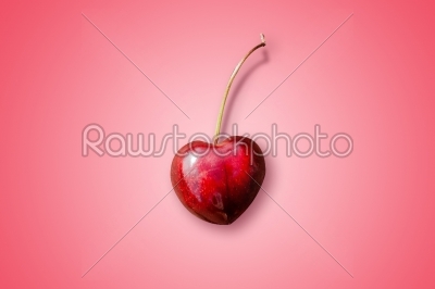 Heart-shaped cherry on a violet background