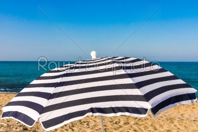 High resolution beach umbrella on blue sky background