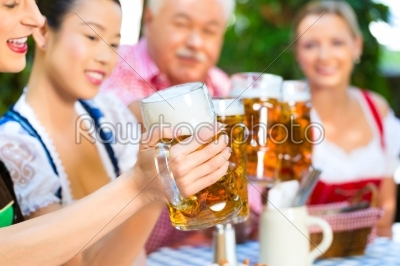 In Beer garden - friends drinking beer in bavaria