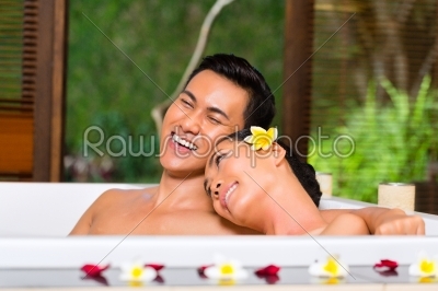 Indonesian couple having wellness bath in spa