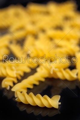 Italian pasta fusilli over black