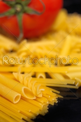 Italian pasta _select_ion and tomato over black