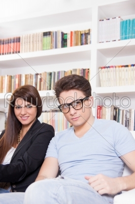 man and woman in the house with lots of books