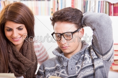 man and woman reading books together at home
