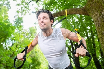man doing suspension trainer sling sport