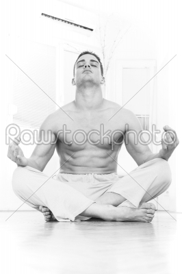 man doing yoga and meditating