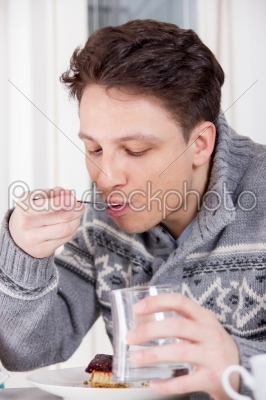 man eating a dessert with a fork