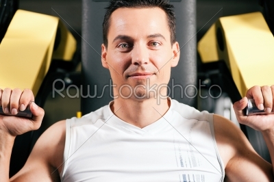 Man exercising and training in gym
