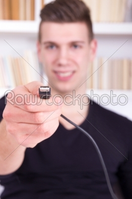 man holding black USB cable
