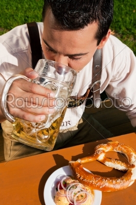 Man in Lederhosen drinking beer
