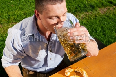 Man in Lederhosen drinking beer