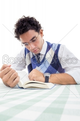 man in pullover with glasses sitting and reads book