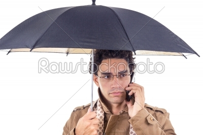 man in the coat with an umbrella on the phone